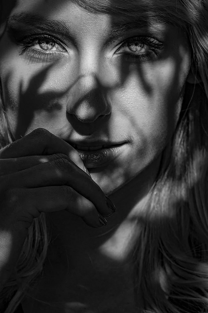 Black and white portrait with shadows across the face